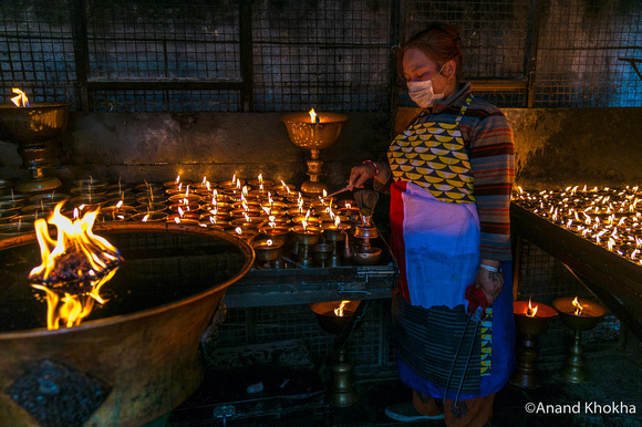 Lighting candles, Bodhnath Buddhist temple