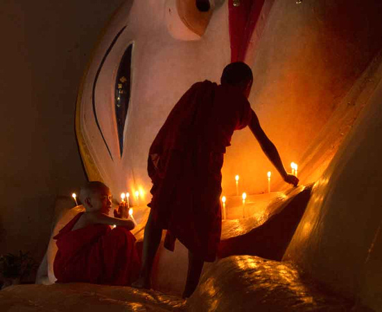 Lighting Candles at Reclining Buddha