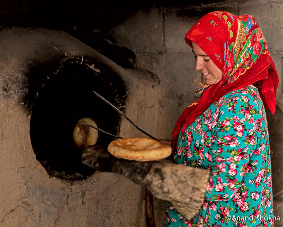 Yaghnobi lady cooking local bread, Tazikstan